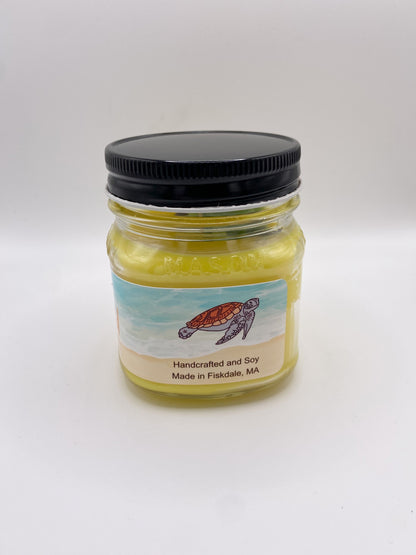 Jar of candle with a turtle label on a white background